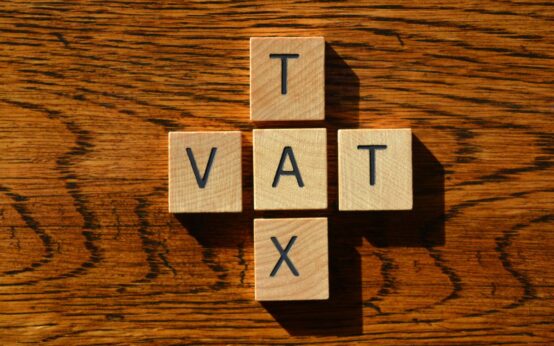 VAT and Tax, words in wooden alphabet letters isolated on wood background